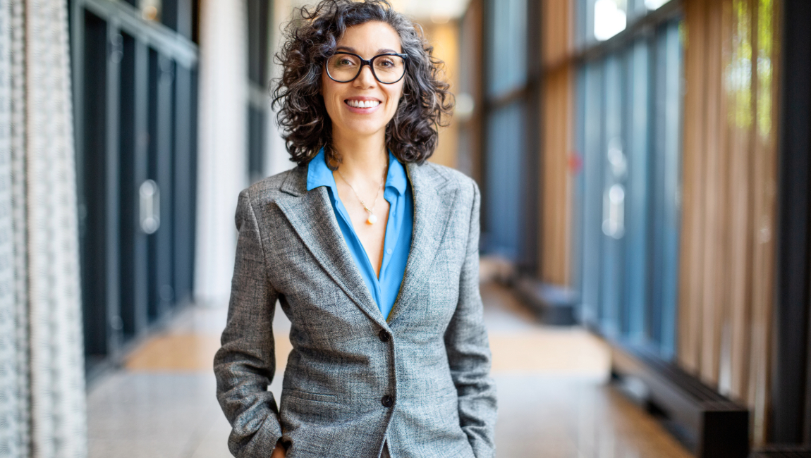 Smiling businesswoman wearing grey suit