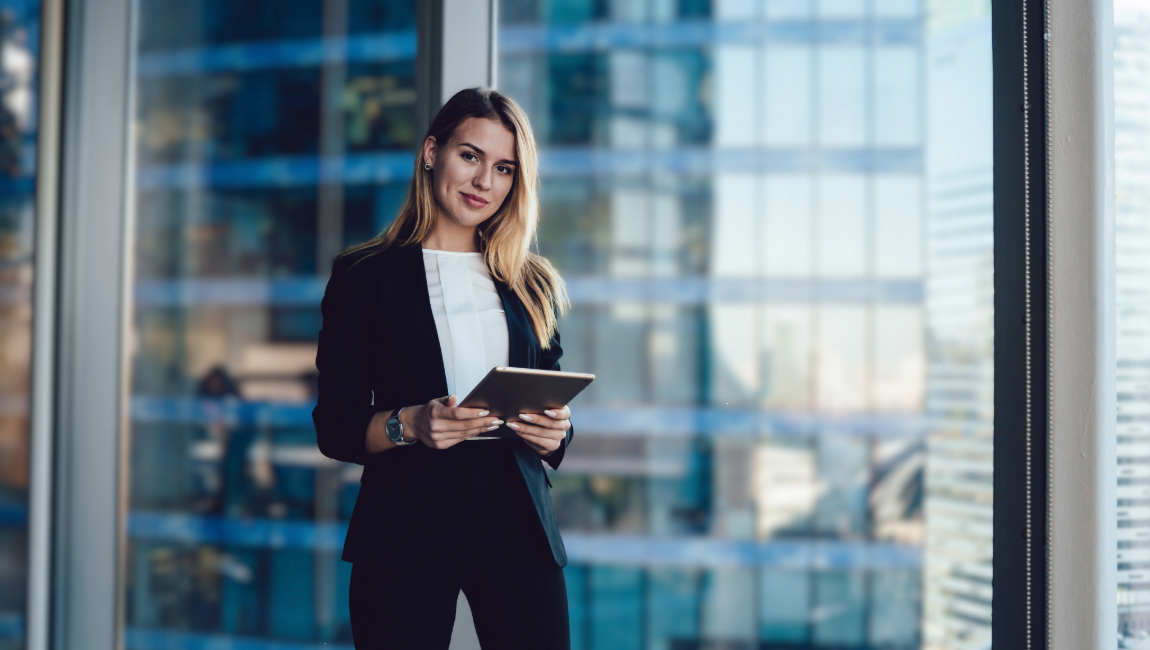 Businesswoman standing while holding tablet