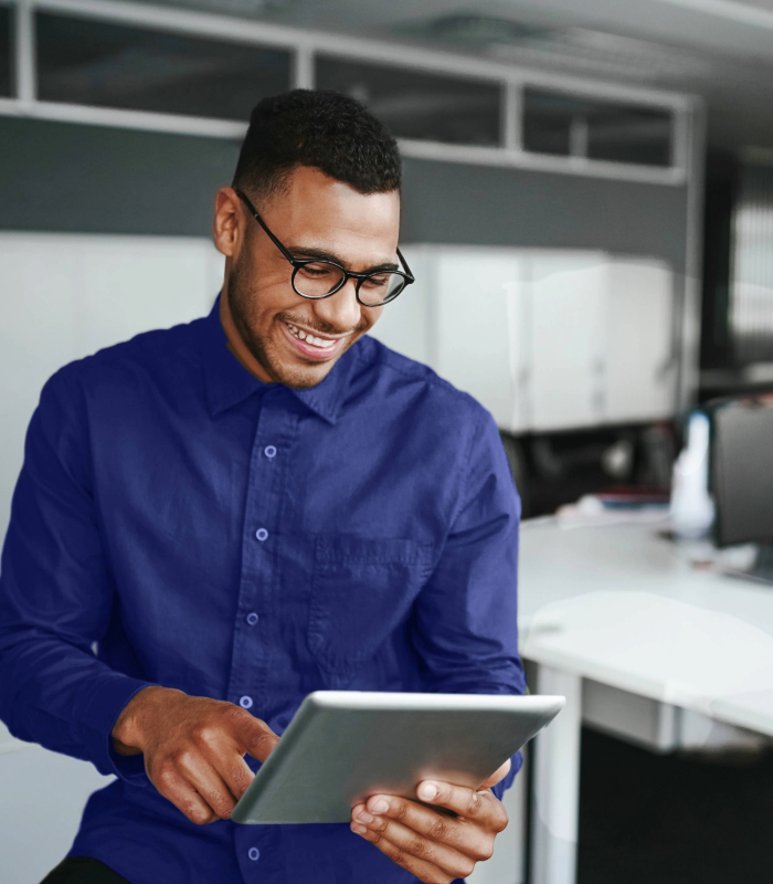 Businessman wearing blue shirt looking at tablet