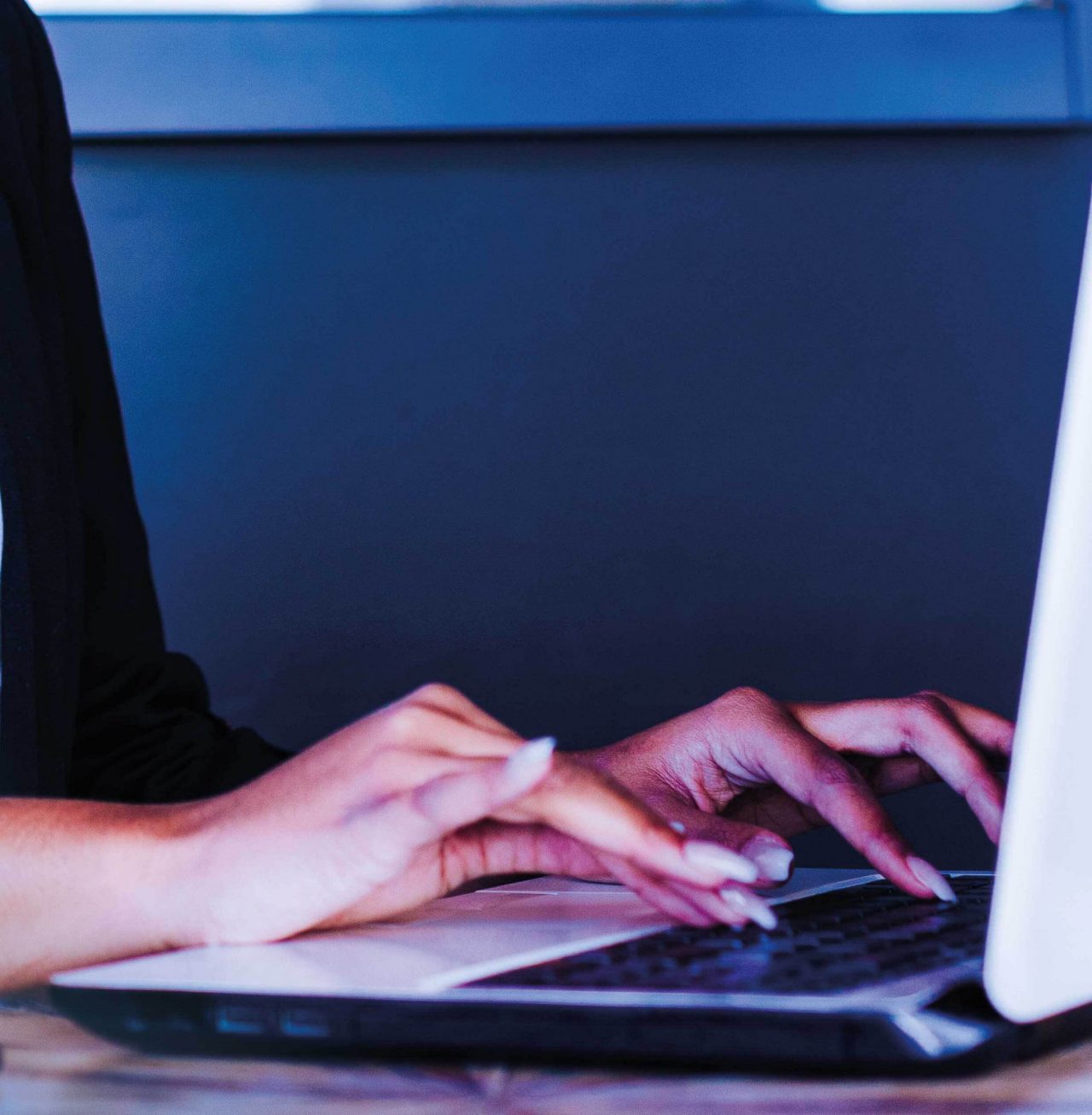 Continuation of businesswoman smiling while typing on laptop