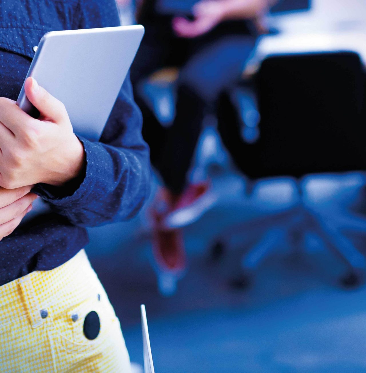 Continuation of smiling businesswoman holding tablet