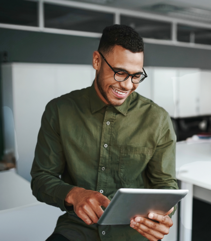 Businessman smiling looking at tablet